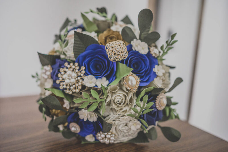 A bouquet of blue and gold flowers on a table.
