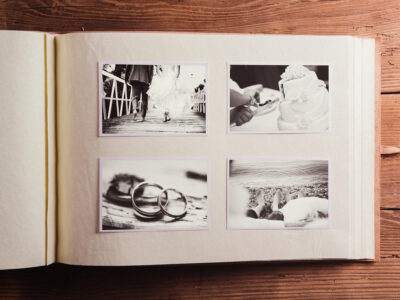 A black and white photo album on a wooden table.