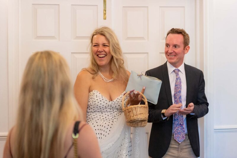 A man and woman laughing in front of a door.