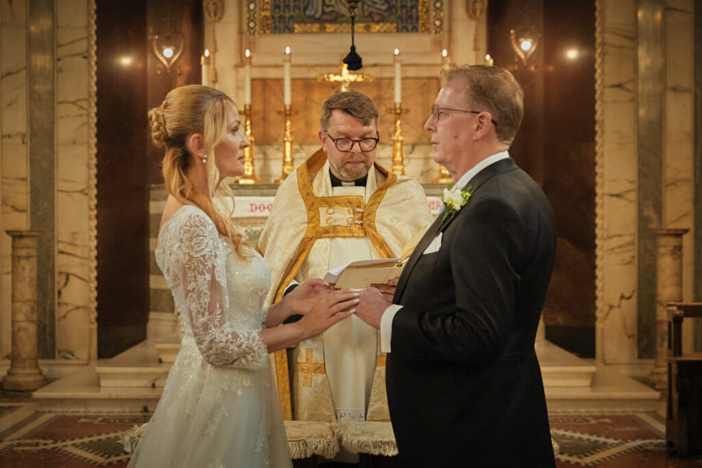 A bride and groom exchange vows in a church.