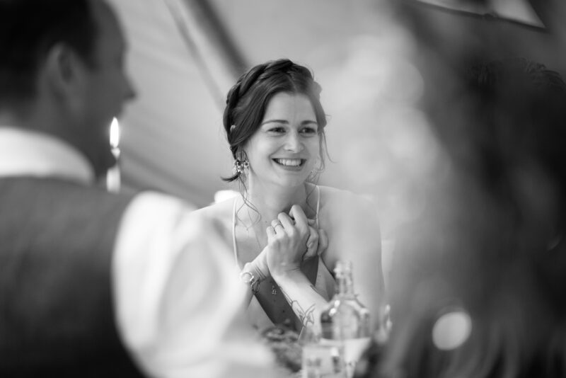 A black and white photo of a bride and groom at a wedding.